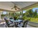 Relaxing screened porch with table and chairs, overlooking backyard at 10604 Se 146Th Ln, Summerfield, FL 34491