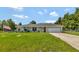 Single-story home with a two-car garage and a large yard at 10604 Se 146Th Ln, Summerfield, FL 34491