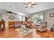 Comfortable living room with sectional sofa, hardwood floors, and ceiling fan at 10604 Se 146Th Ln, Summerfield, FL 34491