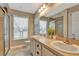 Clean bathroom with double vanity, shower, and updated fixtures at 10604 Se 146Th Ln, Summerfield, FL 34491