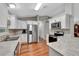 Modern kitchen with white cabinets, stainless steel appliances, and granite countertops at 10604 Se 146Th Ln, Summerfield, FL 34491