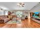 Comfortable living room with hardwood floors and large sectional sofa at 10604 Se 146Th Ln, Summerfield, FL 34491
