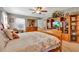 Main bedroom with king-size bed and built-in shelving at 10604 Se 146Th Ln, Summerfield, FL 34491