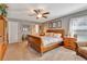 Spacious main bedroom with large wooden bed, ample closet space, and carpeting at 10604 Se 146Th Ln, Summerfield, FL 34491