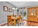 Bright dining room with wooden table and hutch, and access to backyard at 10604 Se 146Th Ln, Summerfield, FL 34491