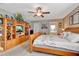 Main bedroom with king-size bed and built-in shelving at 10604 Se 146Th Ln, Summerfield, FL 34491