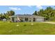 One-story home with a landscaped yard and attached garage at 10604 Se 146Th Ln, Summerfield, FL 34491