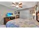 Bright bedroom with a comfortable bed, a large TV, and plenty of closet space at 10604 Se 146Th Ln, Summerfield, FL 34491