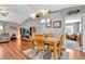 Bright dining area with wood table and chairs, hardwood floors, and access to living room at 10604 Se 146Th Ln, Summerfield, FL 34491