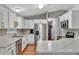Modern kitchen with white cabinets, stainless steel appliances, and granite countertops at 10604 Se 146Th Ln, Summerfield, FL 34491