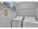 Laundry room with washer, dryer, and ample shelving at 10604 Se 146Th Ln, Summerfield, FL 34491