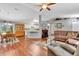 Spacious living room with a brown sectional sofa and hardwood floors at 10604 Se 146Th Ln, Summerfield, FL 34491