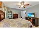 Bright bedroom with a comfortable bed, a large TV, and plenty of closet space at 10604 Se 146Th Ln, Summerfield, FL 34491