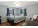 Bright bedroom with a queen bed and hardwood floors at 233 S 4Th St, Lake Mary, FL 32746