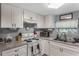 Well-equipped kitchen featuring white cabinets and granite countertops at 233 S 4Th St, Lake Mary, FL 32746