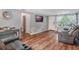 Bright living room with hardwood floors, comfortable seating, and a large TV at 233 S 4Th St, Lake Mary, FL 32746