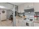 Modern kitchen with white cabinets, granite countertops, and stainless steel appliances at 233 S 4Th St, Lake Mary, FL 32746