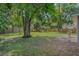 Large backyard with playset, mature trees, and privacy fence at 233 S 4Th St, Lake Mary, FL 32746