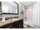 Bathroom with granite countertop, dark brown vanity, and bathtub at 8110 Roseville Rd, Davenport, FL 33896