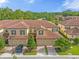 Aerial view of townhouses with tile roofs and lush landscaping at 8110 Roseville Rd, Davenport, FL 33896