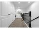 Upstairs hallway with carpet, two closets and black railing at 8110 Roseville Rd, Davenport, FL 33896