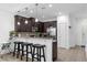 Modern kitchen with dark wood cabinets and breakfast bar at 8110 Roseville Rd, Davenport, FL 33896