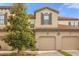 Townhouse exterior with two-car garage and lush landscaping at 8110 Roseville Rd, Davenport, FL 33896