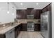 Modern kitchen featuring stainless steel appliances and granite countertops at 8110 Roseville Rd, Davenport, FL 33896