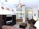 Spacious living room with vaulted ceiling, fireplace and large windows at 320 Henley Cir, Davenport, FL 33896