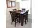 Casual dining area with a square table and four chairs near a window at 320 Henley Cir, Davenport, FL 33896