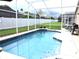 Inviting screened pool with a spacious deck area at 320 Henley Cir, Davenport, FL 33896