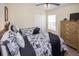 Two twin beds, dresser, and ceiling fan at 320 Henley Cir, Davenport, FL 33896