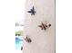 Three Hummingbird shaped hooks on the exterior wall at 320 Henley Cir, Davenport, FL 33896