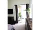 Bedroom with sliding glass doors opening to a private patio and outdoor seating area at 320 Henley Cir, Davenport, FL 33896