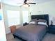 Cozy guest bedroom with a queen-size bed and ceiling fan at 320 Henley Cir, Davenport, FL 33896