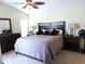 King-size bed in a bright and airy bedroom with ceiling fan at 320 Henley Cir, Davenport, FL 33896