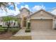 Attractive single-story home with a two-car garage and landscaped front yard at 320 Henley Cir, Davenport, FL 33896