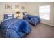 Two twin beds, nightstands, and a window in a well-lit bedroom at 320 Henley Cir, Davenport, FL 33896