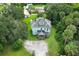 Aerial view of a large light teal colored house with mature trees and a large lot at 2341 Celery Ave, Sanford, FL 32771