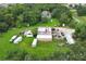 Aerial view of a property with a large workshop, containers and vehicles at 2341 Celery Ave, Sanford, FL 32771