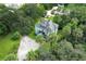 An aerial view of a large light teal colored house with mature trees and a large lot at 2341 Celery Ave, Sanford, FL 32771