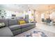 Open living room with gray sectional sofa and kitchen view at 7525 Sunflower Cir, Kissimmee, FL 34747