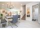 Bright dining area with glass table, chandelier, and gray chairs at 7525 Sunflower Cir, Kissimmee, FL 34747