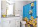Bathroom with granite countertop, and a fun Minion-themed shower curtain at 7525 Sunflower Cir, Kissimmee, FL 34747