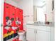 Bathroom with granite countertop and Mickey Mouse theme at 7525 Sunflower Cir, Kissimmee, FL 34747