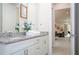 Bathroom with double vanity, granite countertops, and view to living area at 7525 Sunflower Cir, Kissimmee, FL 34747