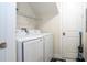 Laundry room with washer, dryer, and shelving at 7525 Sunflower Cir, Kissimmee, FL 34747
