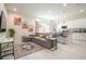 Open concept living room and kitchen with grey sectional sofa and modern kitchen at 7525 Sunflower Cir, Kissimmee, FL 34747