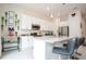Modern kitchen with island, white cabinets, and granite countertops at 7525 Sunflower Cir, Kissimmee, FL 34747