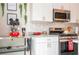 Modern kitchen with white cabinets, granite counters, and stainless steel appliances at 7525 Sunflower Cir, Kissimmee, FL 34747